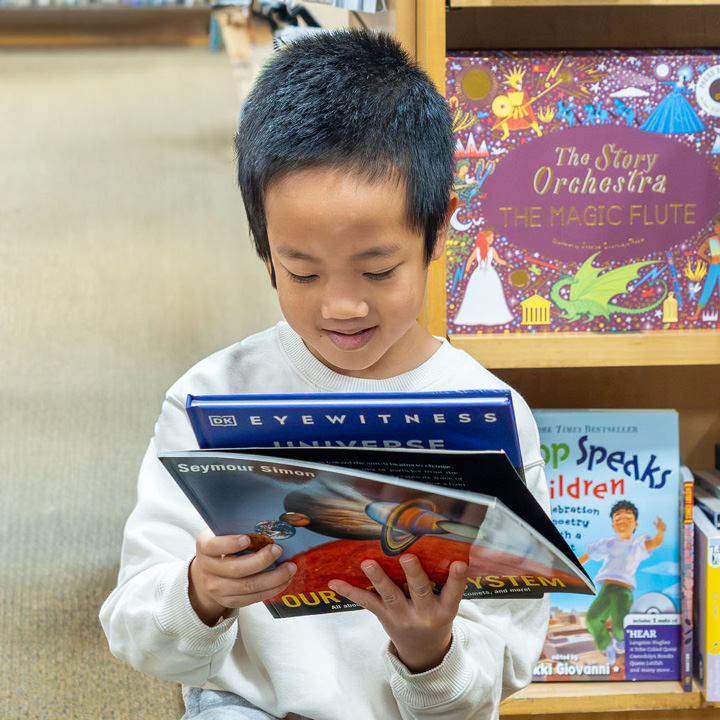 A small kid enjoying new books